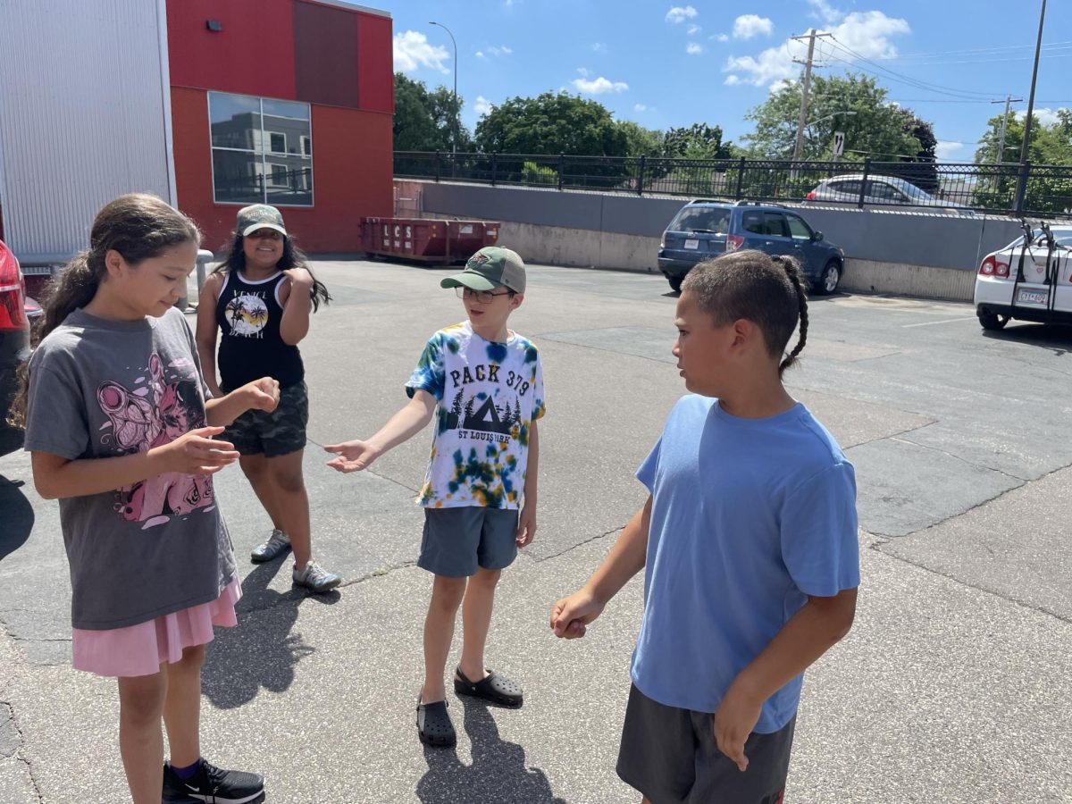 Kamille Wilson holds a grasshopper during a field activity with fellow youth journalists at SPEAK MPLS, capturing a moment of curiosity, courage, and growth. Small steps like these can build resilience every day. (Eric Ortiz)